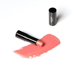 Henne Organics Lip Tint in SUNLIT, a beautiful peachy-pink color.